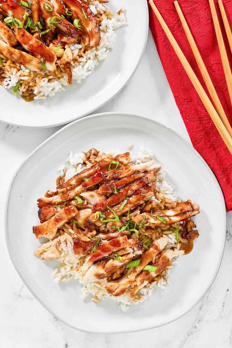 Copycat Panda Express grilled teriyaki chicken on two plates.