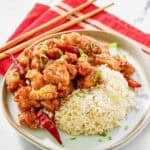 Copycat Panda Express hot orange chicken and rice on a plate.