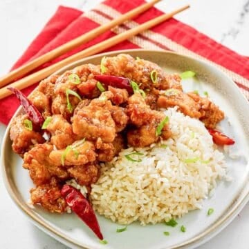 Copycat Panda Express hot orange chicken and rice on a plate.