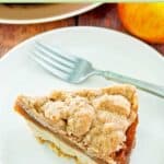 Apple crumb coffee cake and a fork on a small plate.