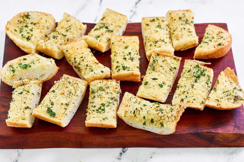 Copycat Brennan's garlic bread on a wood serving board.