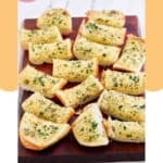 Slices of homemade Brennan's garlic bread on a wood board.