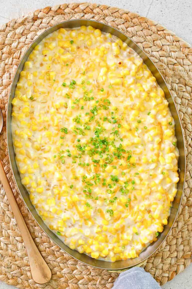 Cheesy creamed corn in a large copper skillet.