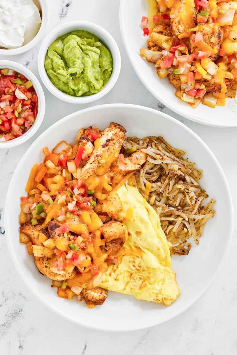 Copycat Denny's chicken fajita breakfast skillet, sour cream, salsa, and guacamole.