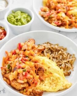 Copycat Denny's chicken fajita breakfast skillet, guacamole, salsa, and sour cream.