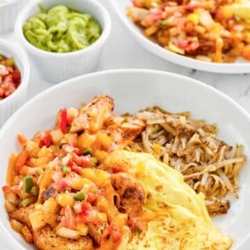 Copycat Denny's chicken fajita breakfast skillet, guacamole, salsa, and sour cream.