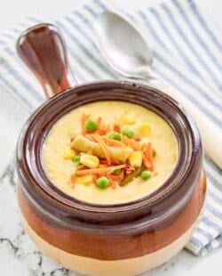 Copycat Dolly Parton Dixie Stampede creamy vegetable soup in a soup crock.