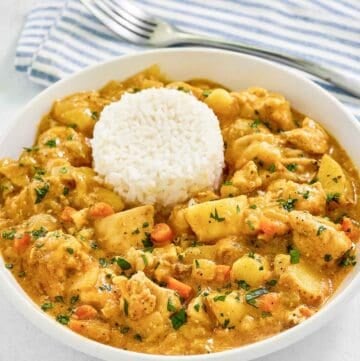 Instant Pot Thai yellow chicken curry in a bowl and a fork on a napkin.