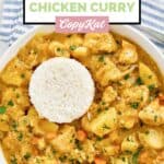 Instant pot Thai yellow chicken curry with white rice in a bowl.