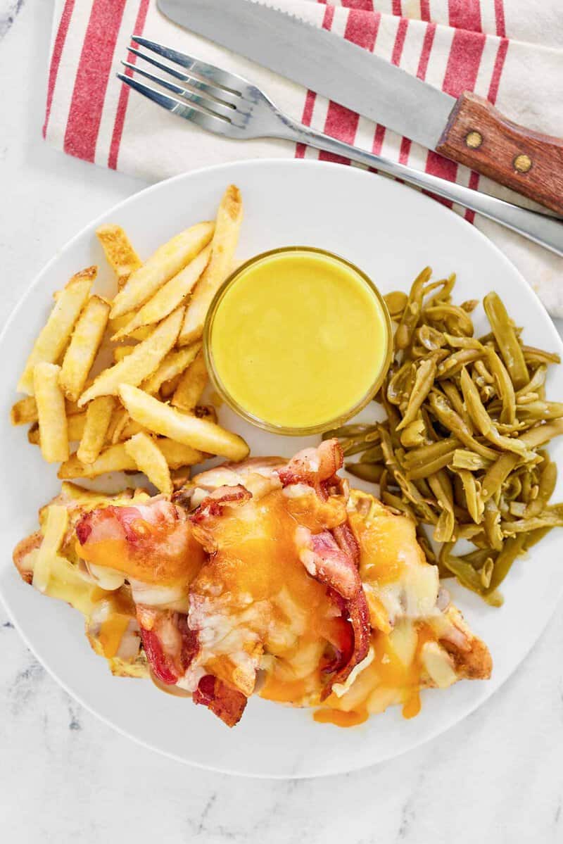 Copycat outback steakhouse alice springs chicken, honey mustard sauce, fries, and green beans.