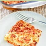 Pumpkin dump cake slice and a fork on a dessert plate.