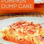 A slice of pumpkin dump cake and a fork on a plate.