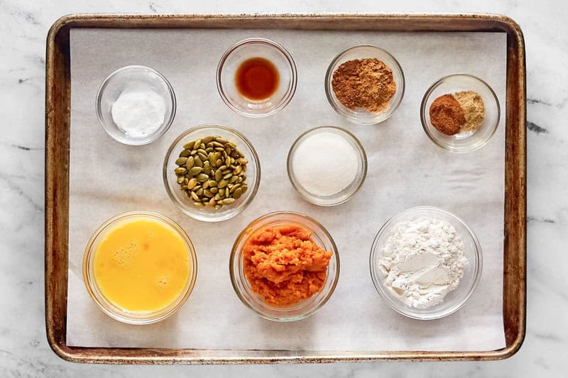 Copycat starbucks pumpkin bread ingredients in bowls on a tray.