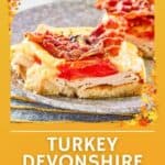 Turkey Devonshire open faced sandwich on a plate.