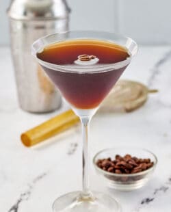 Copycat chili's espresso martini and a small bowl of espresso coffee beans.