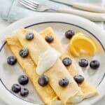 Copycat ihop lemon ricotta crepes on a plate.