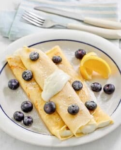 Copycat ihop lemon ricotta crepes on a plate.