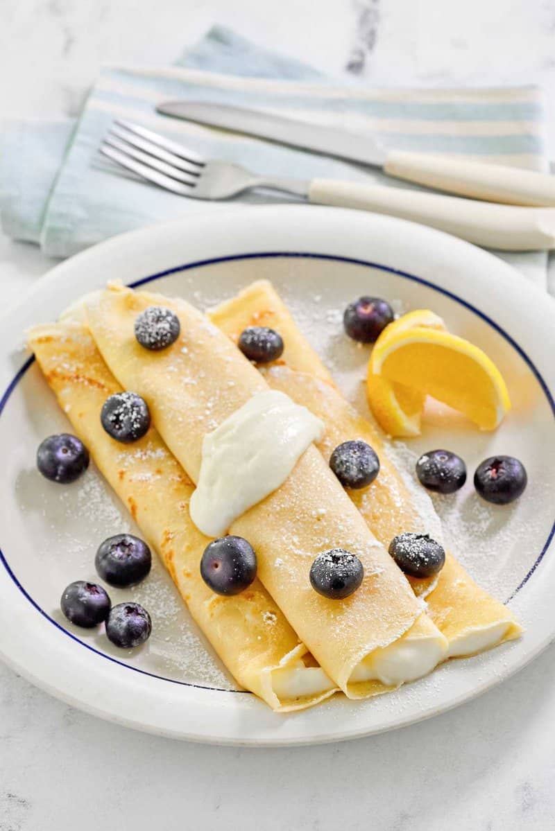 Copycat ihop lemon ricotta crepes on a plate.