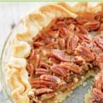 Karo syrup pecan pie in a glass pie plate.