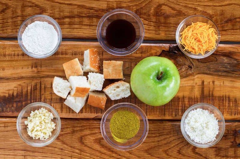 Copycat Melting Pot cheddar cheese fondue ingredients on a wood surface.