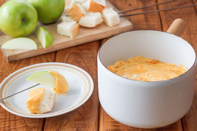 Copycat Melting Pot cheddar cheese fondue in a fondue pot.