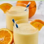 Homemade orange julius ganished with an orange wedge.