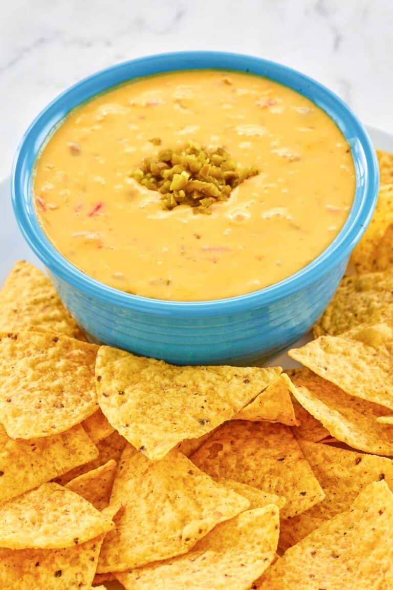 Copycat Pappasito's queso dip and tortilla chips next to it.