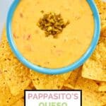 Homemade pappasito's queso dip and tortilla chips on a platter.