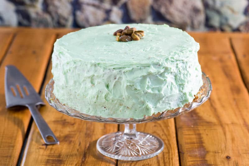 Pistachio cake on a cake stand.