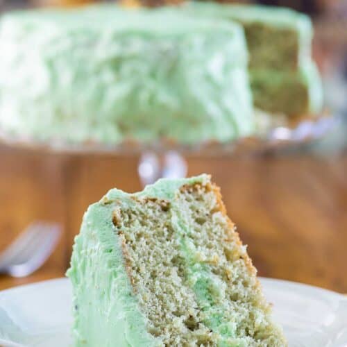 Homemade pistachio cake and a slice on a plate.