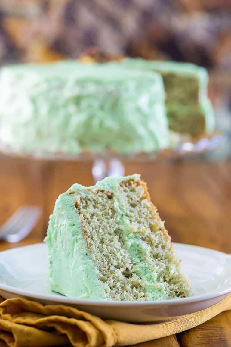 Homemade pistachio cake and a slice on a plate.