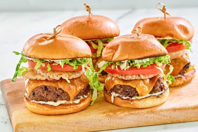 Copycat red robin banzai burgers on a wood serving board.