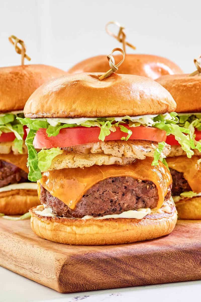 Copycat red robin banzai burger on a wood cutting board.