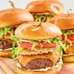 Homemade red robin burgers on top of a wood board.