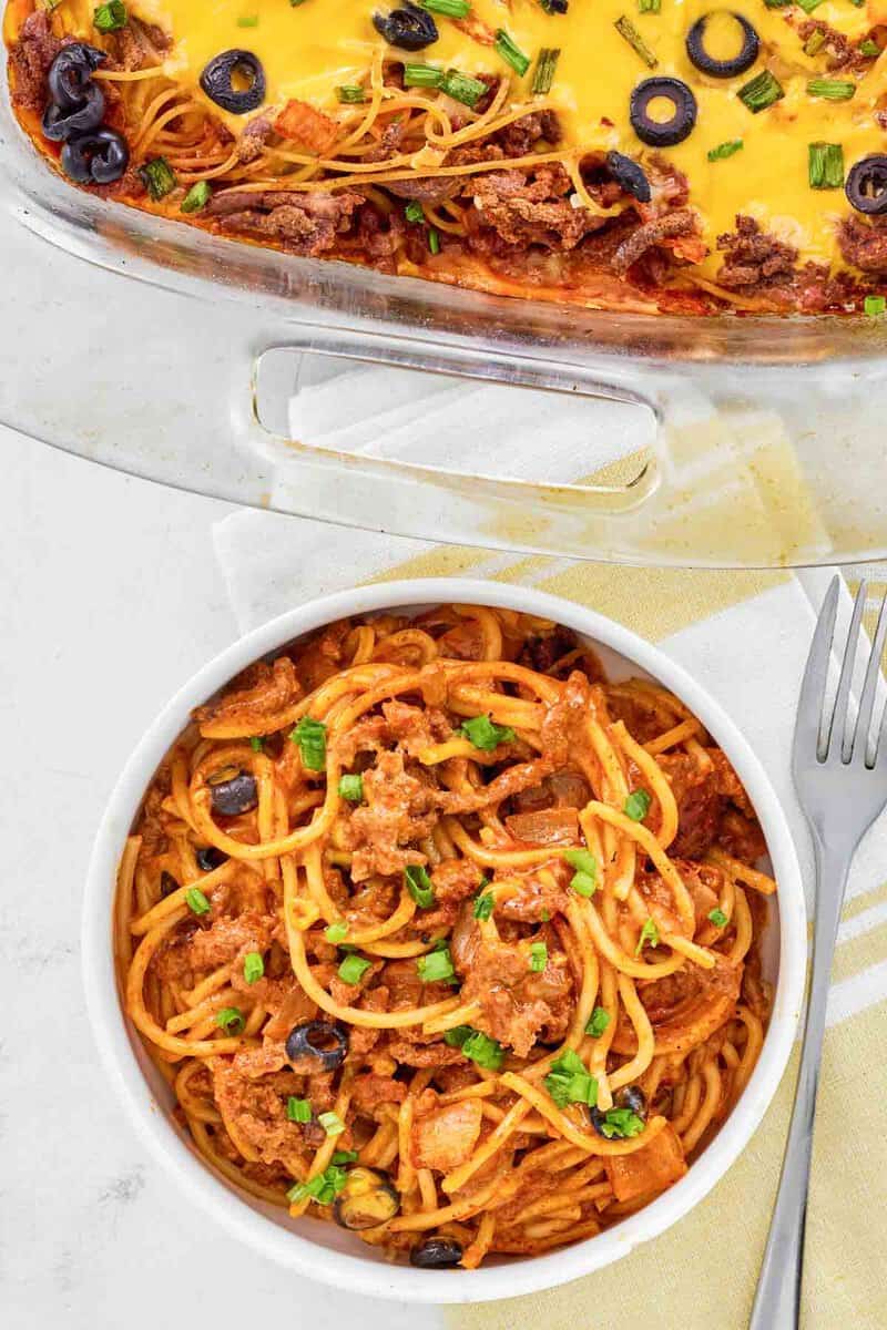 Taco spaghetti casserole in a bowl and baking dish.