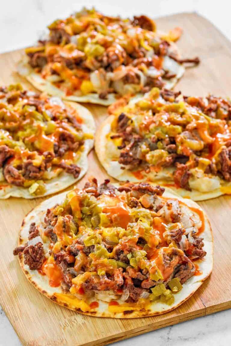 Copycat taco villa mexican pizza things on a wood serving board.