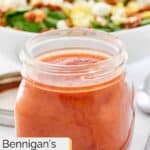 Homemade Bennigan's hot bacon dressing in a small glass jar.