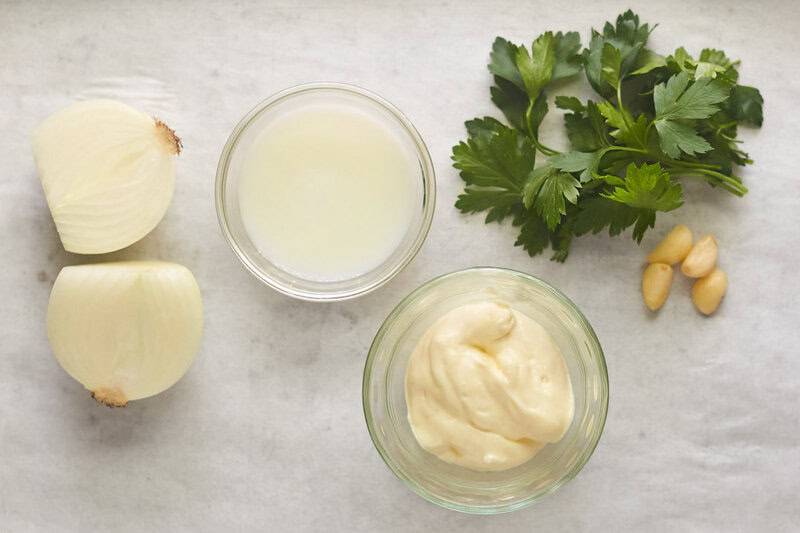 Homemade buttermilk ranch dressing ingredients on parchment paper.