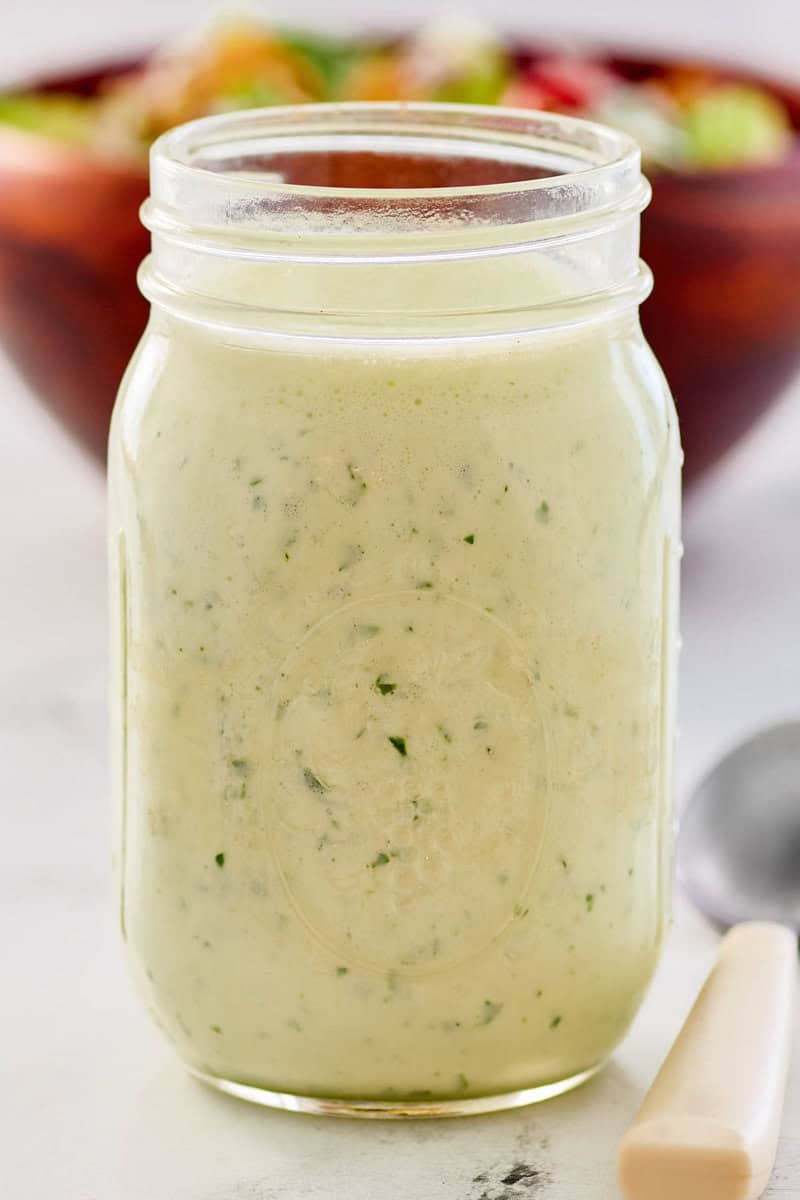 A mason jar filled with homemade buttermilk ranch dressing.