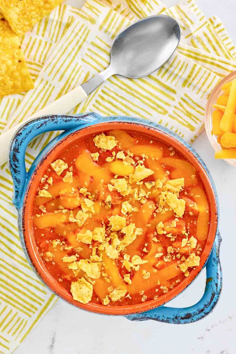 Copycat ground round chicken tortilla soup and a spoon on a napkin.