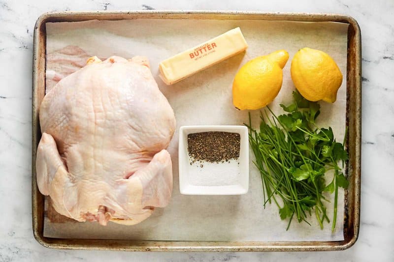 Whole roasted chicken ingredients on a tray.