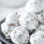 Homemade rum balls piled on a plate.