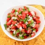 Copycat TGI Friday's pico de gallo with tortilla chips on a plate.