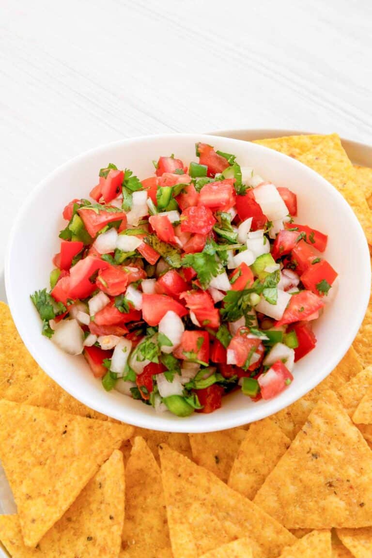 Copycat TGI Friday's pico de gallo with tortilla chips on a plate.