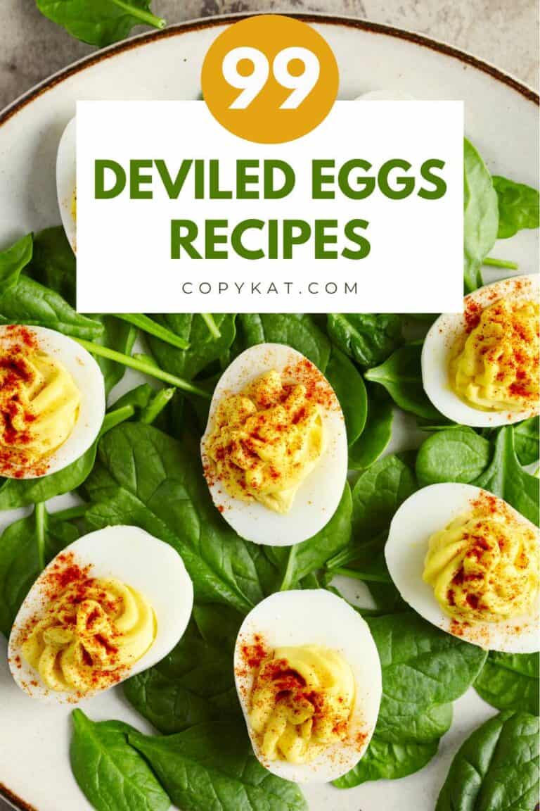 Deviled eggs on top of spinach leaves on a plate.