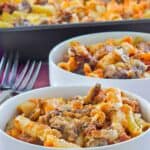 Homemade baked ziti in two bowls and a baking dish.