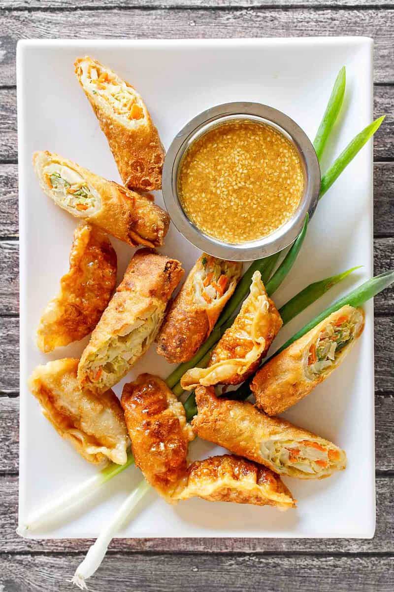 Copycat Benihana magic mustard sauce and egg rolls on a platter.