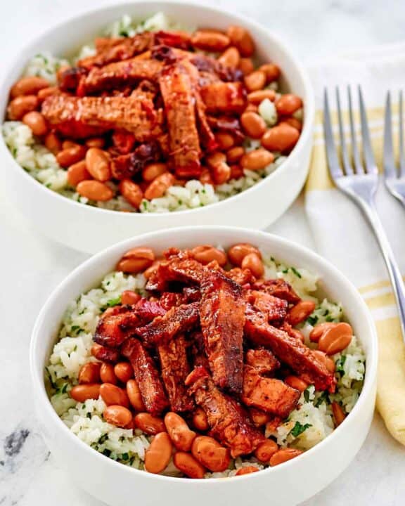 Copycat Chipotle smoked brisket over rice in two bowl.