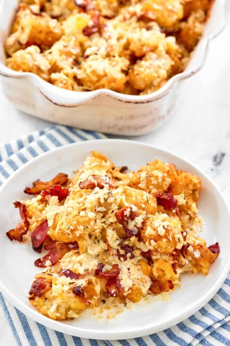 Copycat Domino's cheddar bacon loaded tots on a plate and in a serving dish.