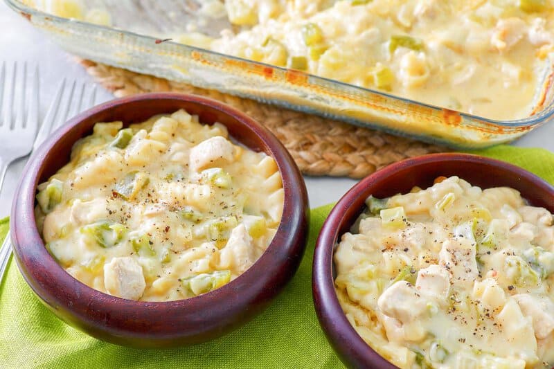 Everyday chicken casserole with cheese and noodles in a baking dish and bowls.